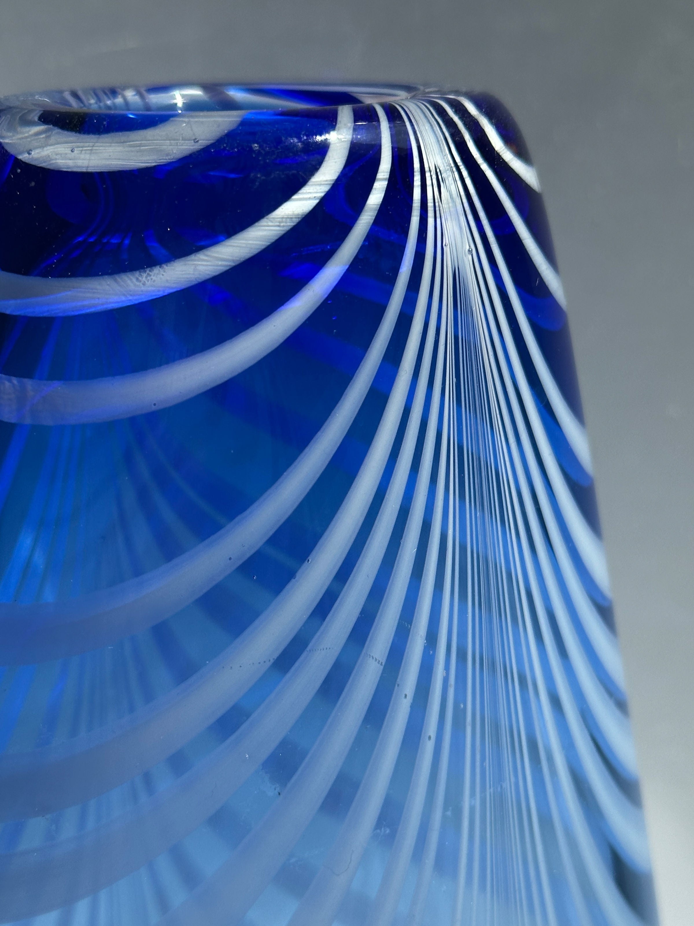 Blue and white striped glass vase detail showing swirled pattern