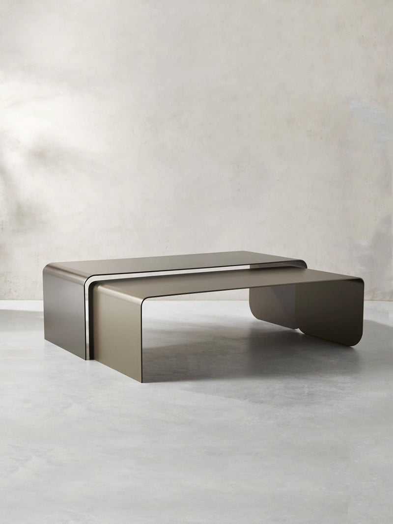 Nesting coffee tables with curved bronze metal design