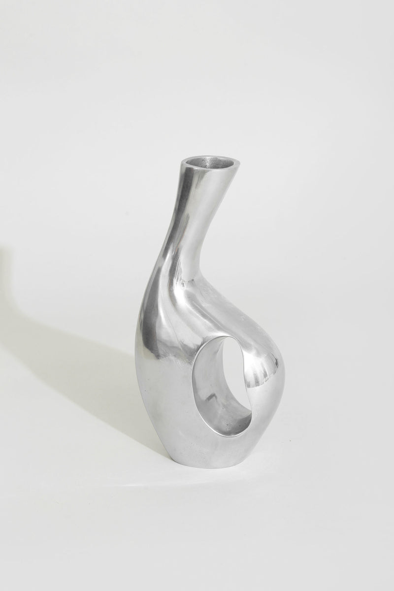 Chrome sculptural vase with curved opening and modern design