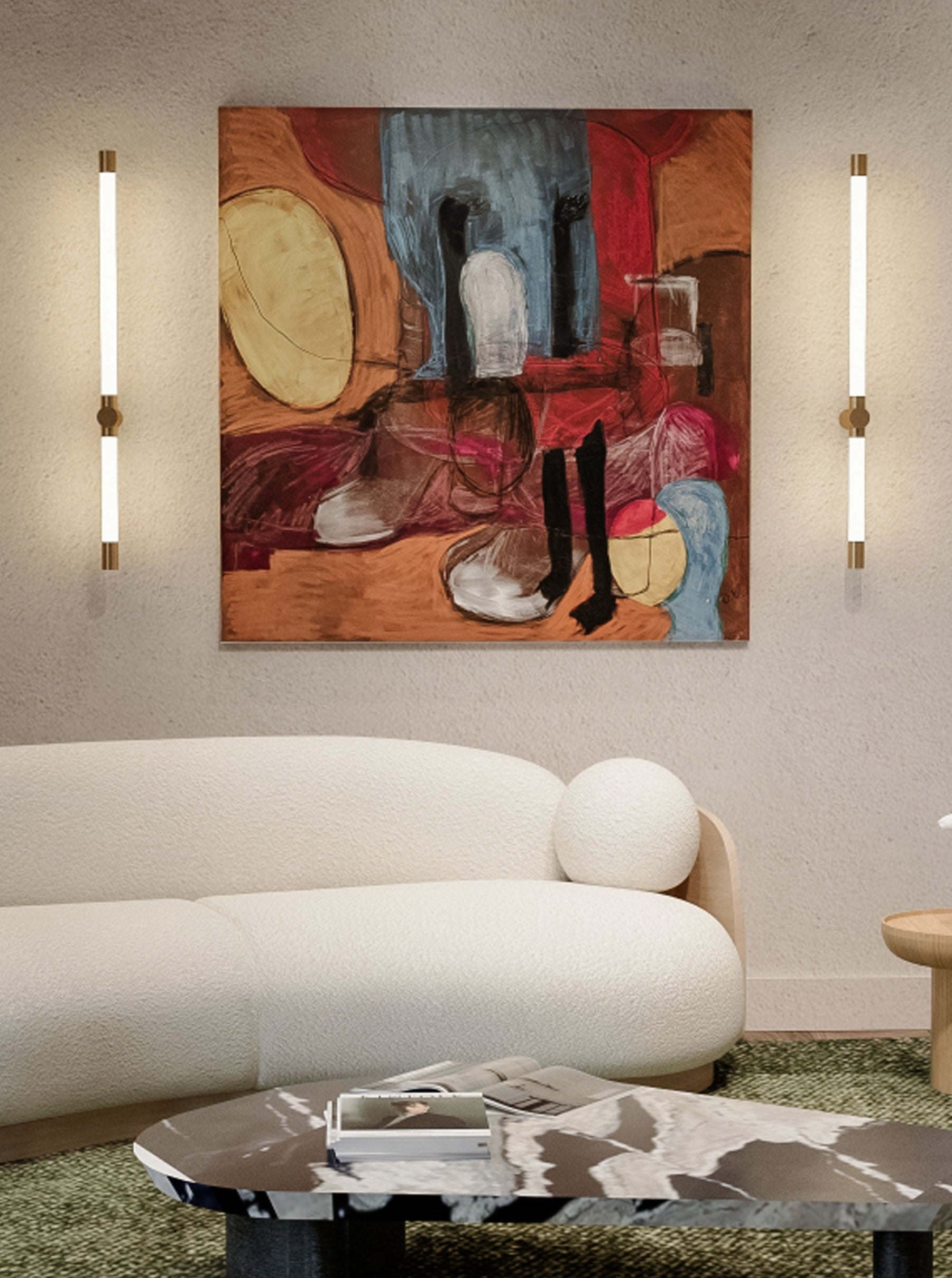 A modern living room features a white, rounded sofa with textured upholstery. Above it hangs "Whispers of Dreams" by Dovile Bernotaite, an acrylic, oil pastel, dry pastel, and charcoal masterpiece. Two vertical light fixtures flank the artwork, enhancing its symbolic imagery. A black and white marble coffee table sits in the foreground with a book on it.