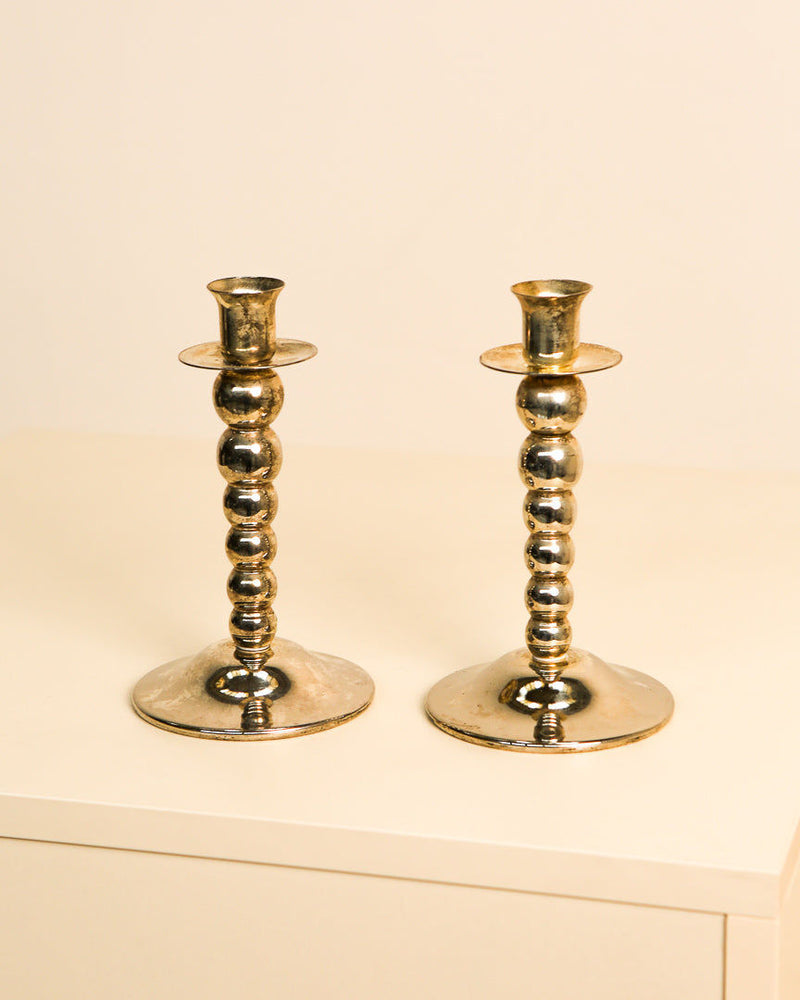 Pair of golden brass Italian candlesticks with beaded stems