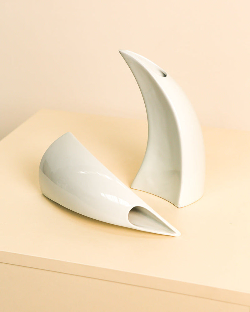 Curved white ceramic vases showing sculptural profile view