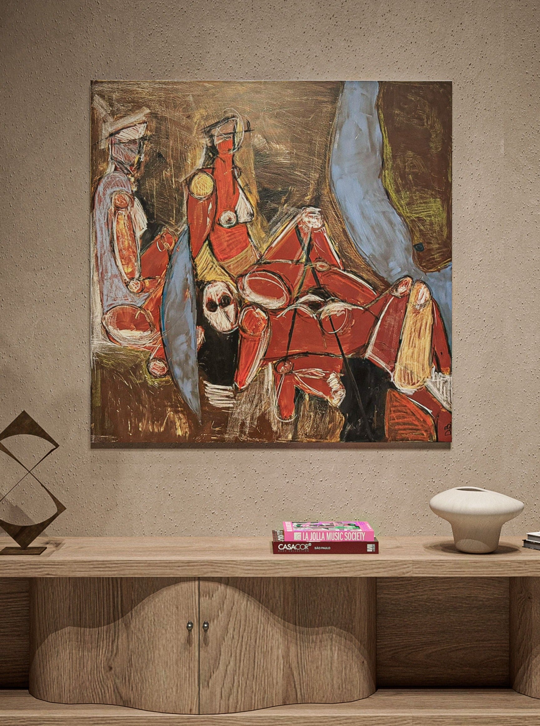 A unique artwork titled "Deadly flirt" by Dovile Bernotaite, featuring abstract figures with angular red forms and brown and blue highlights hangs on a beige textured wall. Below it, a wooden shelf supports a few books, including one titled "CASA COOK," and two modern decorative items.