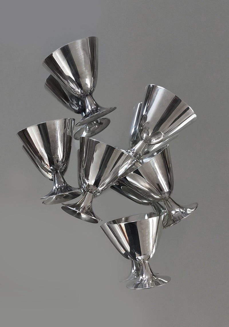 Set of 6 Christofle Cups by Les Objoies arranged stylishly against a plain gray background. Their silver-plated surfaces reflect elegance and modernity, showcasing timeless luxury in home decor.