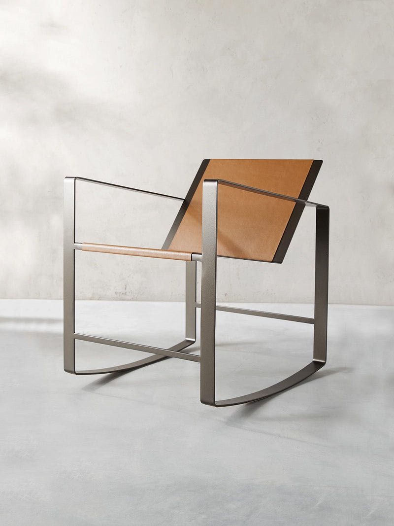 Modern steel frame rocking chair with tan leather seat and backrest