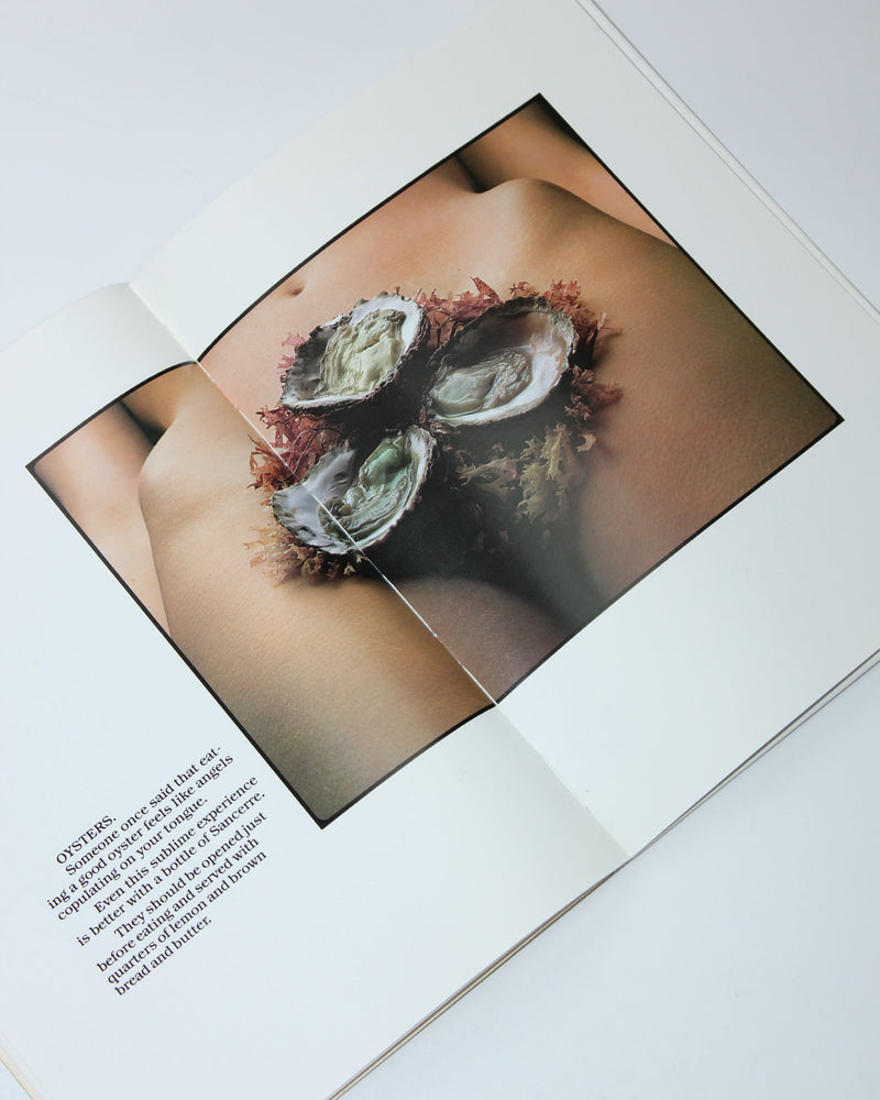 Open Rude Food art book showing oysters arranged on human torso