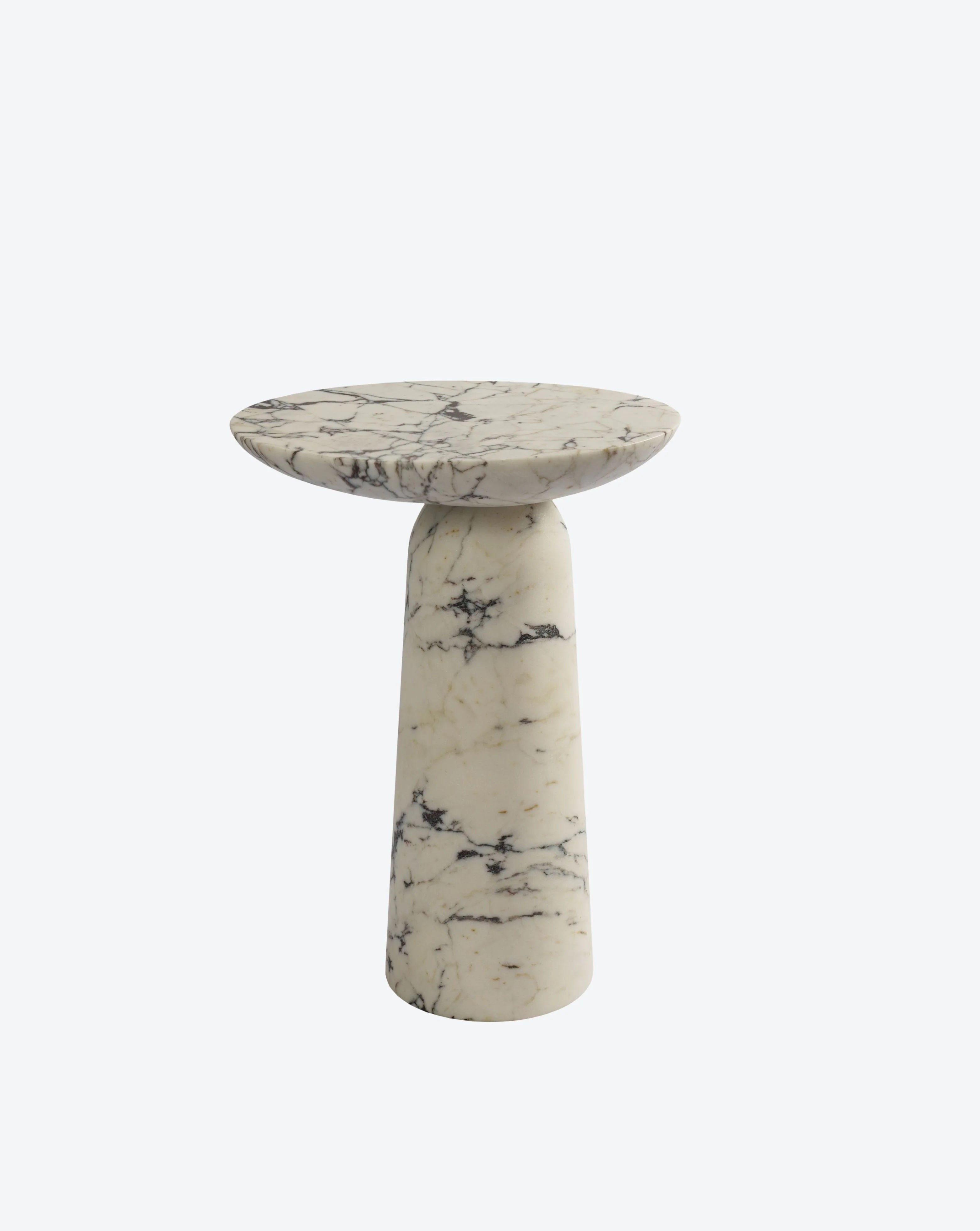 The Athena Marble Side Table by Ransom & Dunn is a petite round piece featuring a pedestal base made from Calacatta Viola marble, adorned with dark, intricate veins. Its smooth tabletop accentuates the marble's natural elegance against a simple white backdrop, exquisitely handcrafted in Europe.