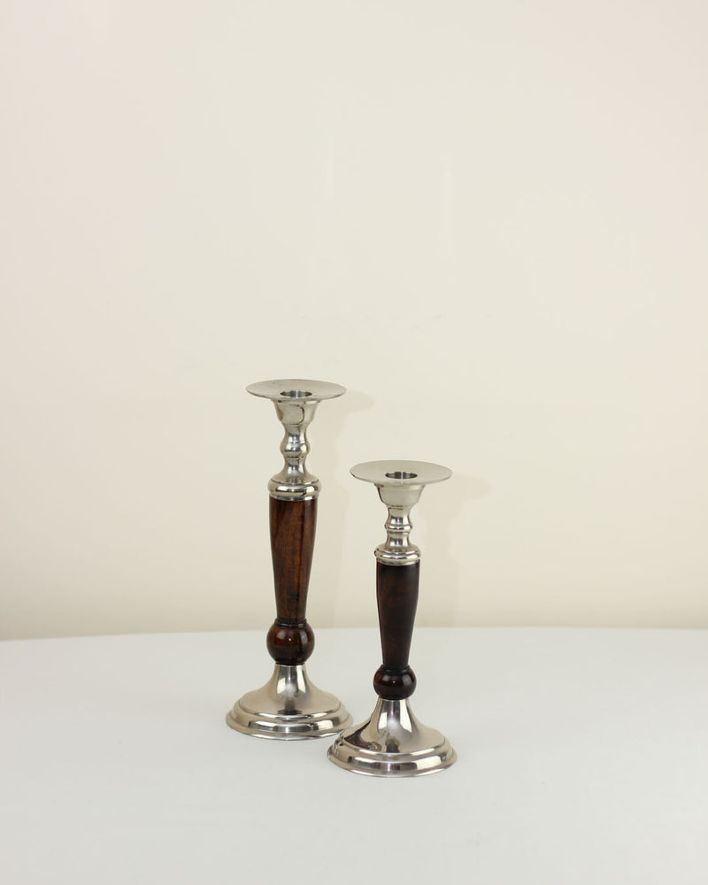 Elegant wood and brass candlesticks pair on white surface