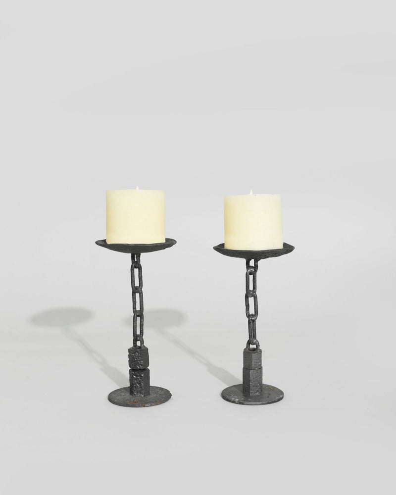 Pair of black iron chain candleholders with cream pillar candles