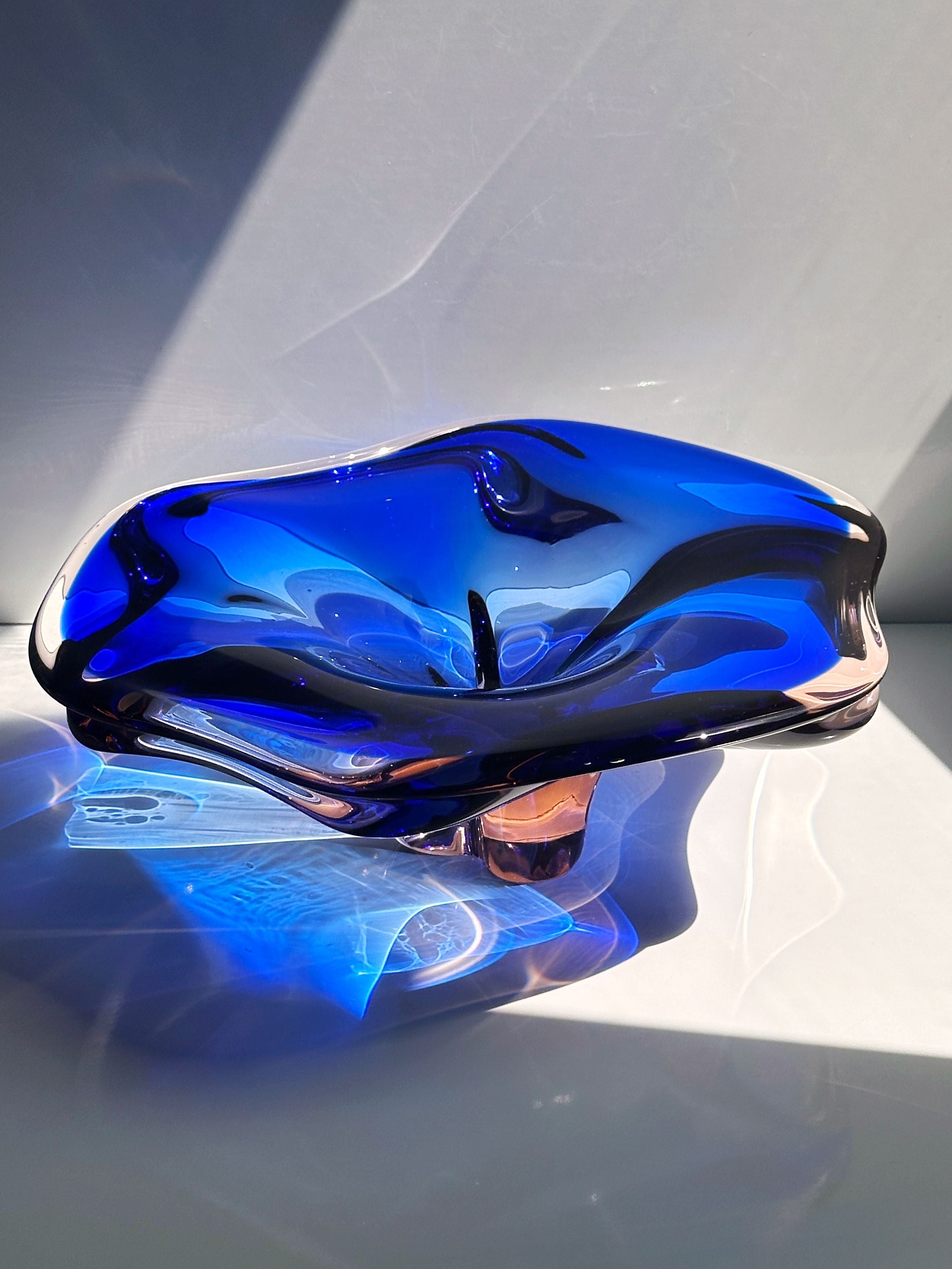 Large cobalt blue Bohemian glass bowl showing curved organic form