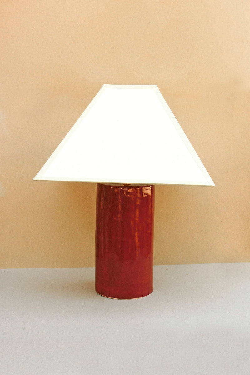 The Hacienda Lamp (Granada) features a unique bell-shaped design and a distressed finish, adding a rustic and elegant touch to any home decor