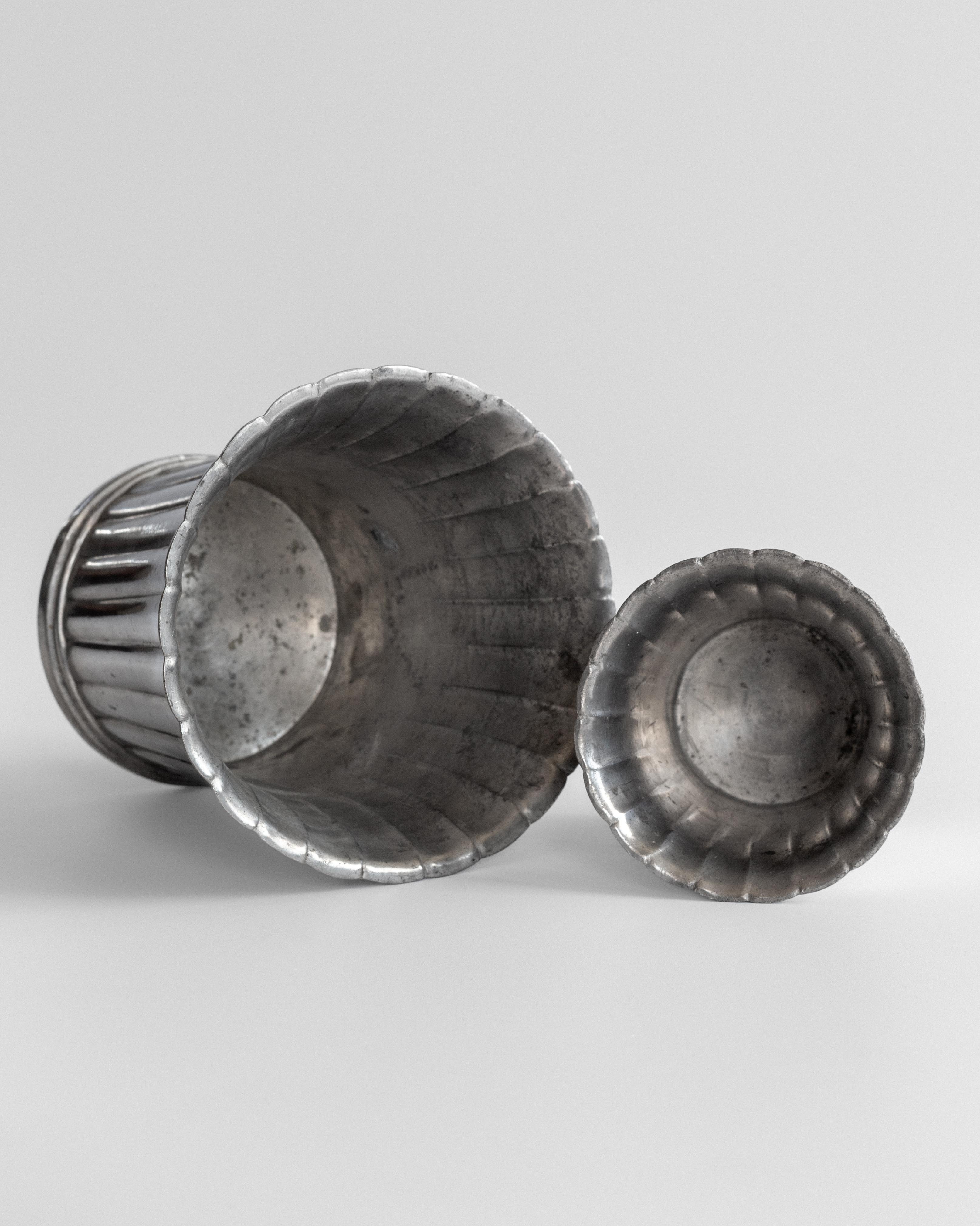 Fluted pewter vase set interior view showing ridged pattern detail