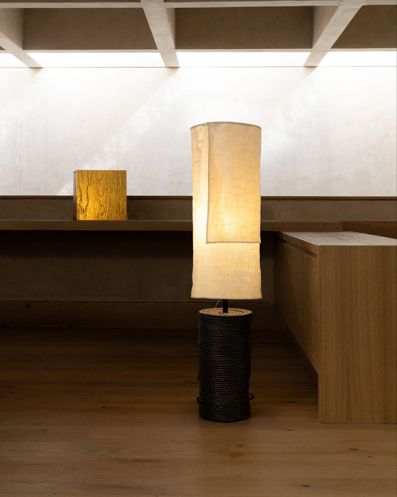 Lazo floor lamp with woven base and cream fabric shade by Peca