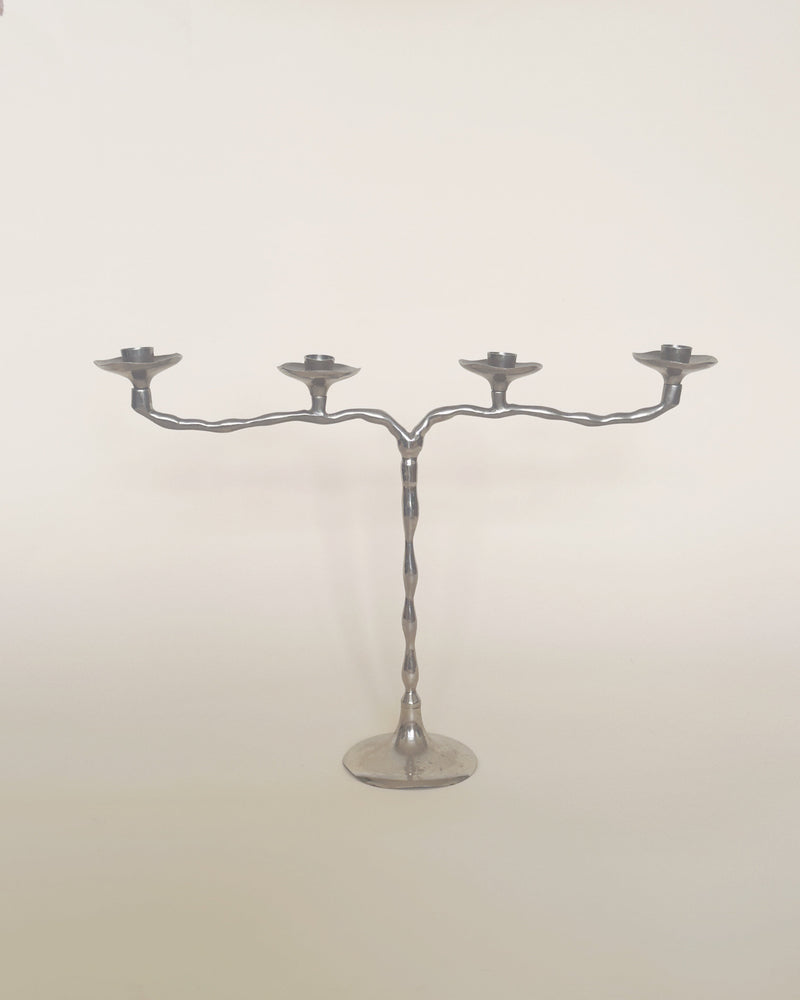 Chrome four-arm candelabra with twisted metal stem and round base