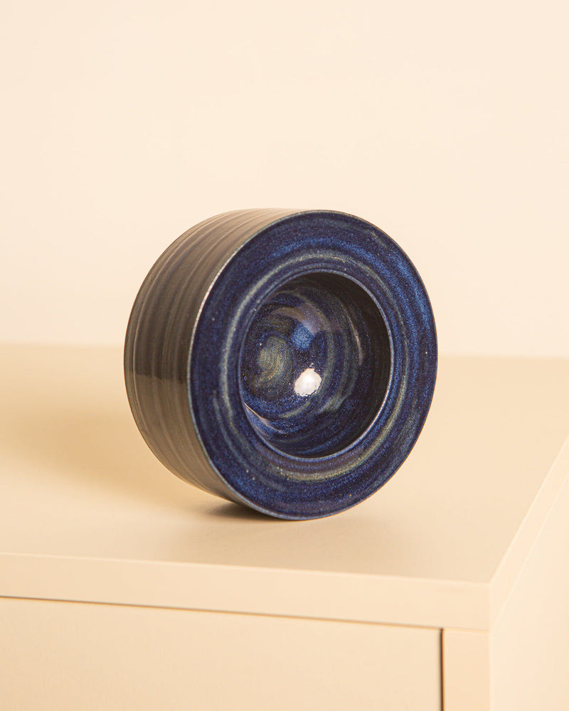 Deep blue ceramic vide-poche with concentric spiral interior detail