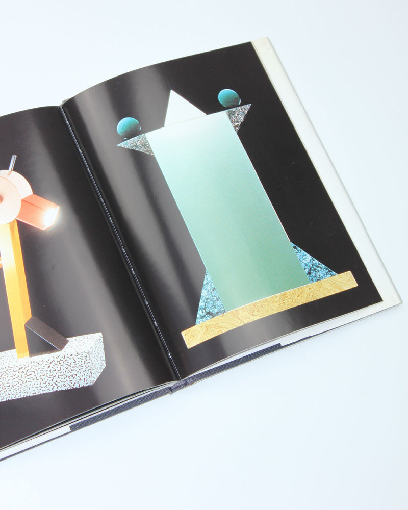 Memphis design book open showing geometric shapes and postmodern furniture