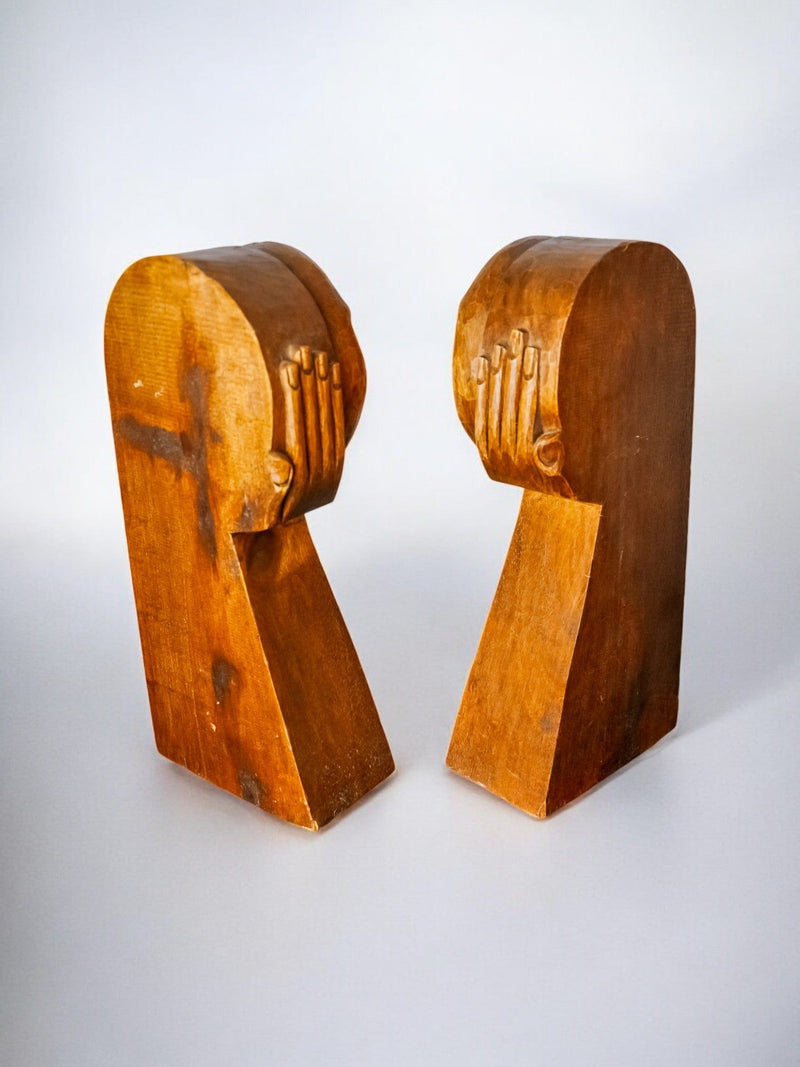 Carved wood bookends profile view showing sculptural head details