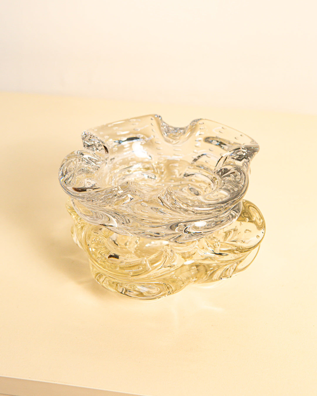 Stacked clear Murano glass ashtrays with swirled texture detail