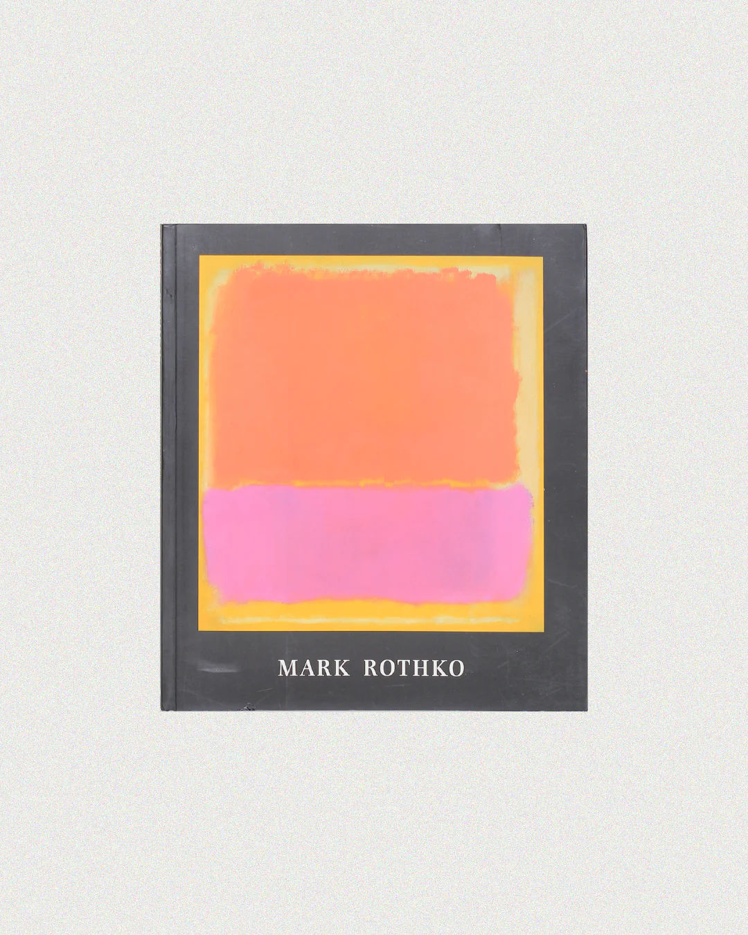 The "Mark Rothko Book" by Boga Avante Shop features a cover with Colour Fields of Abstract Expressionism—a vibrant orange rectangle above a soft pink one on a yellow background—and is completed with a sleek black spine.