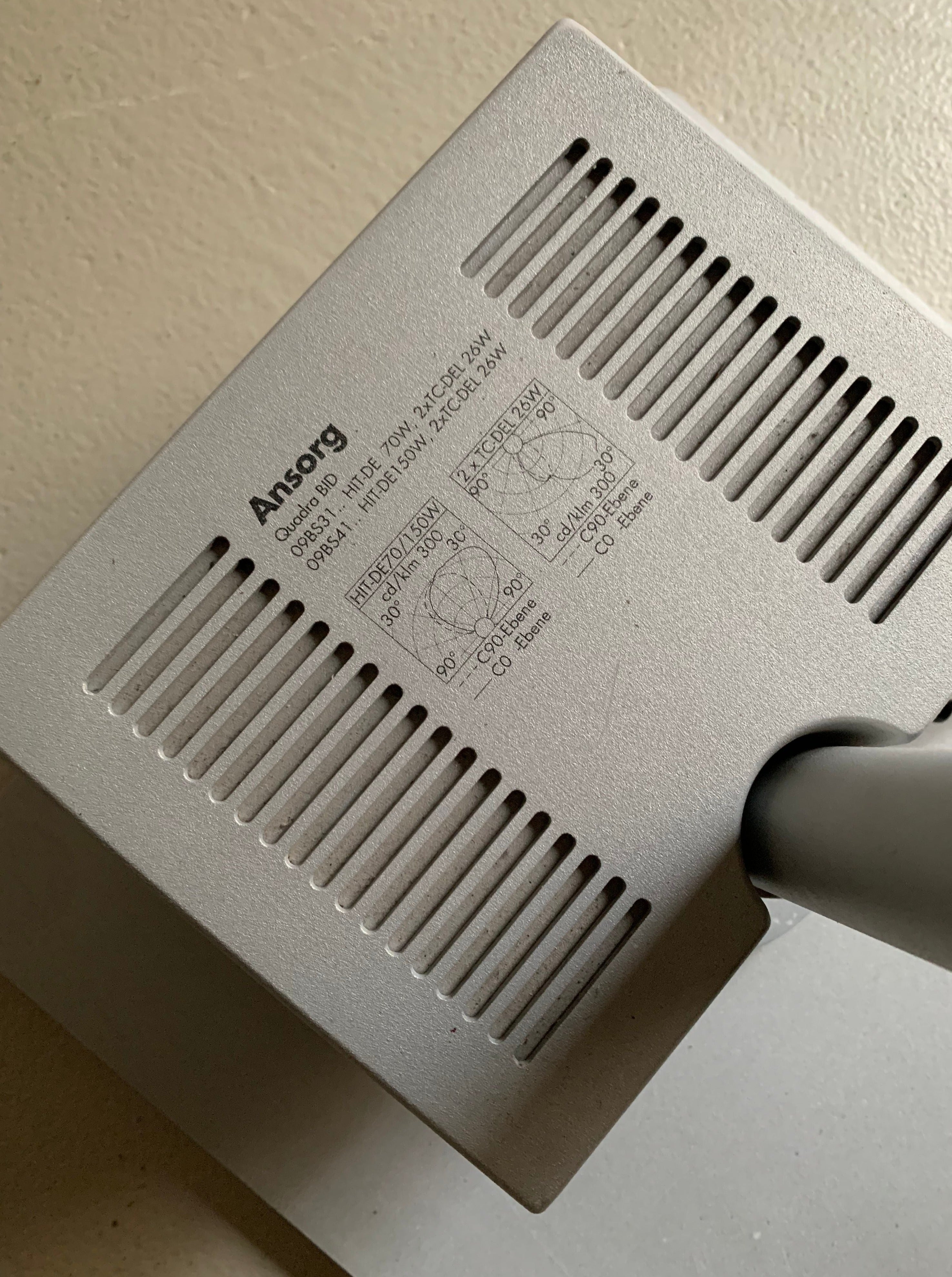 Close-up of a grey electronic device stamped with the brand "Veter Vintage", featuring technical diagrams and text, including serial numbers and compliance marks for the Postmodern Metal Lamp by Glen Oliver Löw and Antonio Citterio for Ansorg | 1990s system, viewed at an angle.