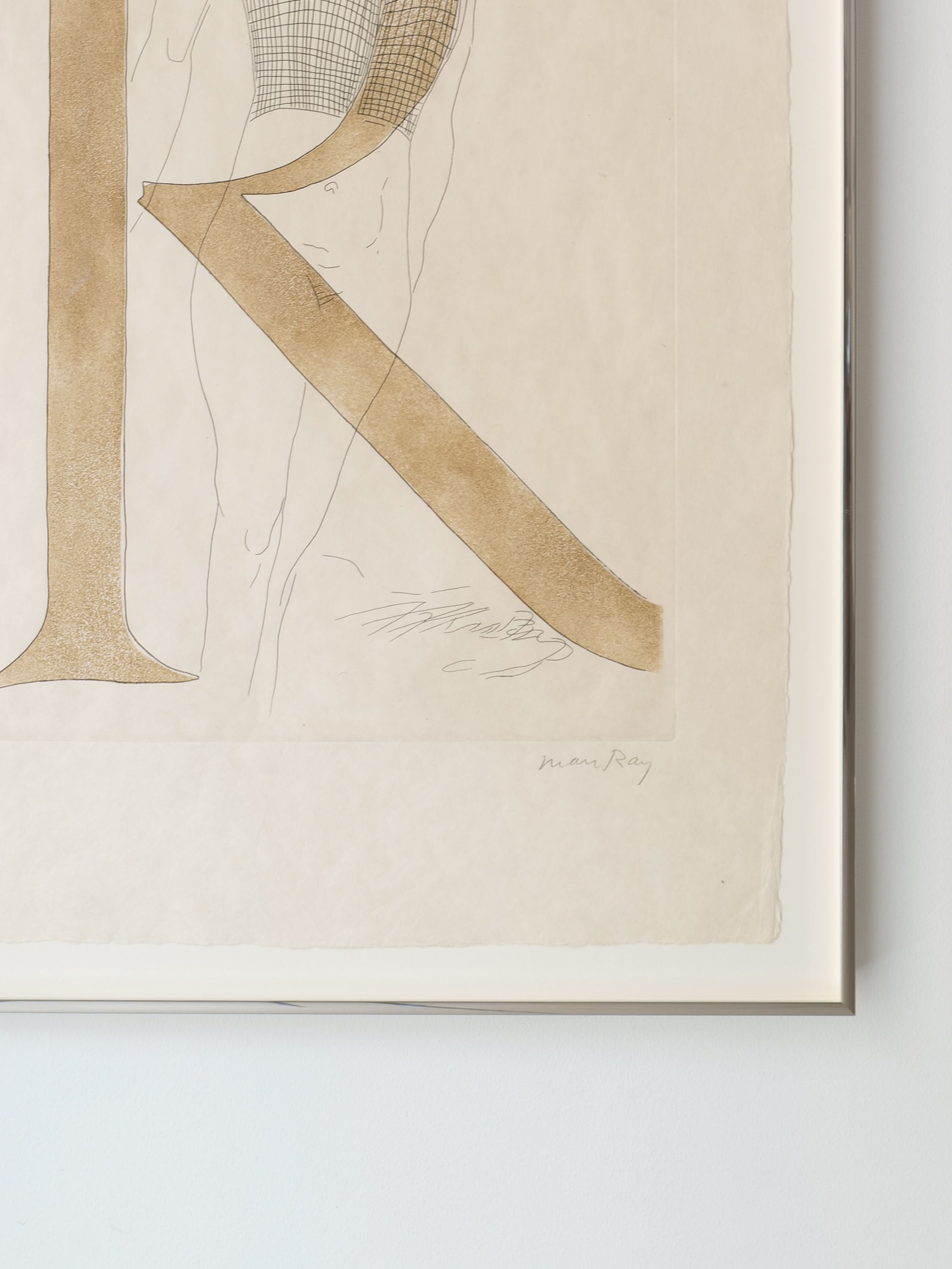 The "Man Ray Etching 'Renee' 1970" by Collection apart showcases a large abstract letter "R" in brown tones subtly outlining a human figure, echoing the Surrealist movement. The piece features the artist's signature and is a limited numbered etching displayed on a pristine white wall.