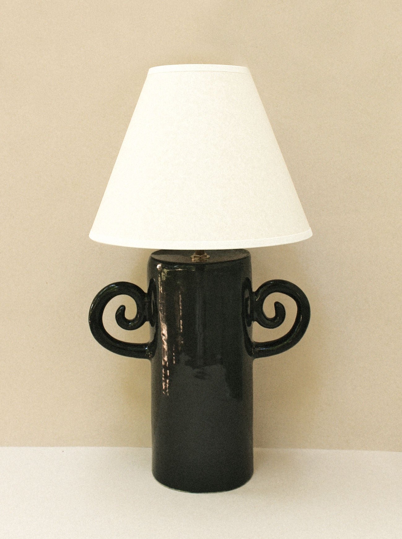 A side view of the Espiral Lamp - Grande black, highlighting its large size and modern, minimalist style