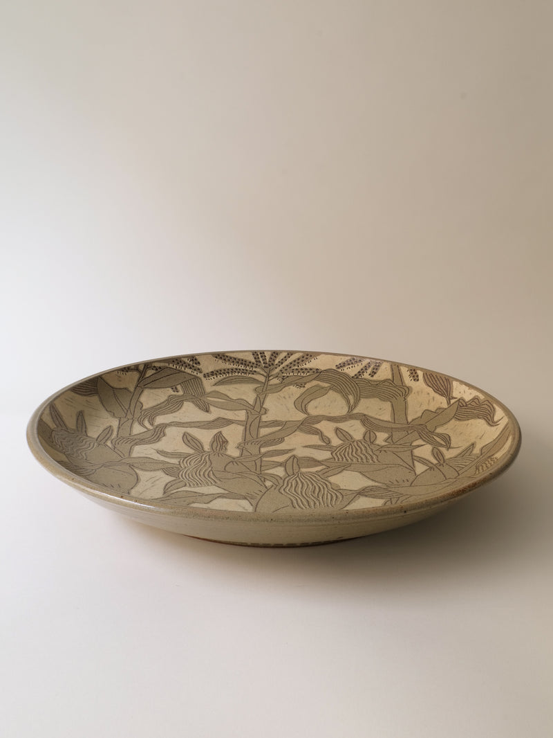 A Ceramic Plate from Kenji Sugiura, Japan 1980s, by Collection apart features intricate brown floral and plant designs on a tan background reminiscent of Shōwa period style, resting on a plain white surface.