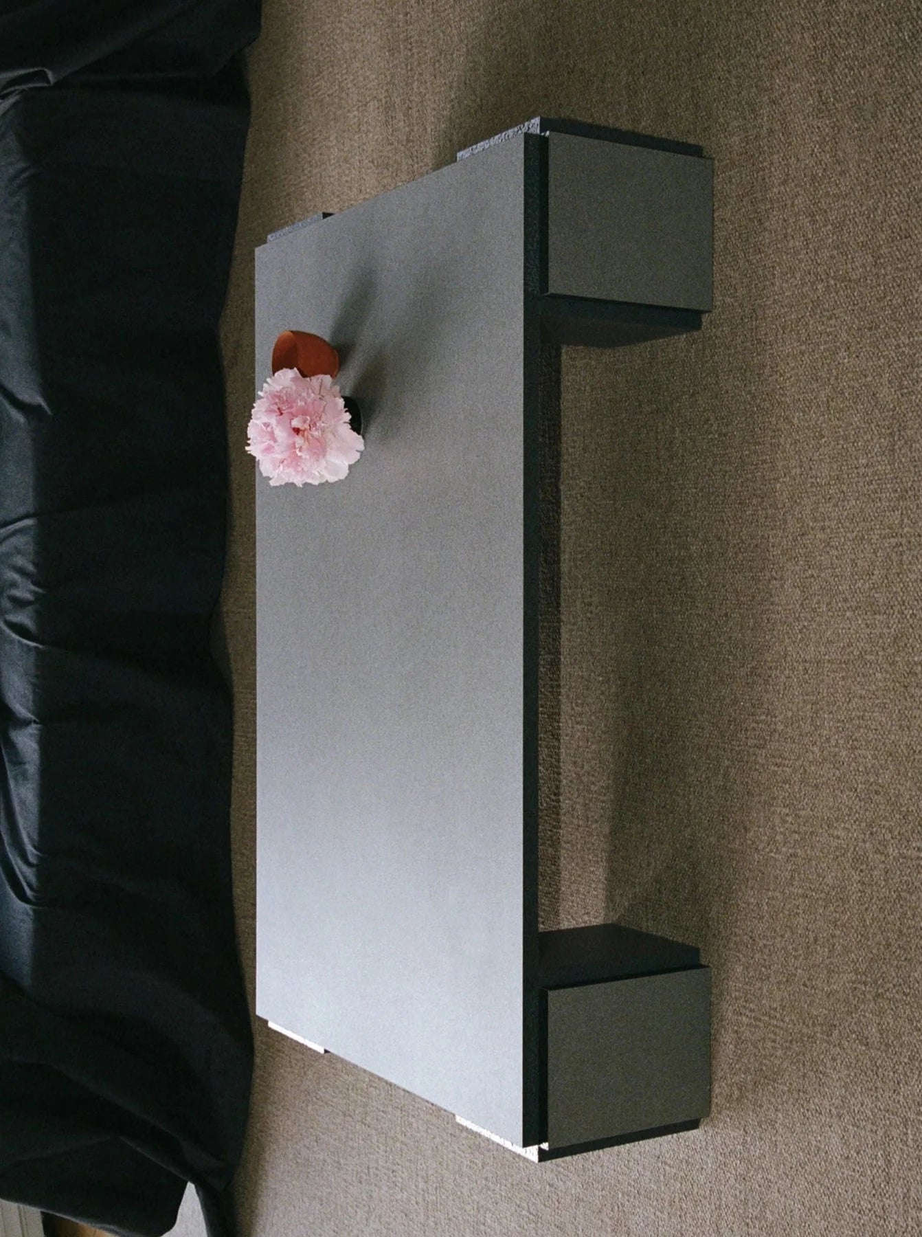 Mara coffee table with dark cube legs and pink carnation detail