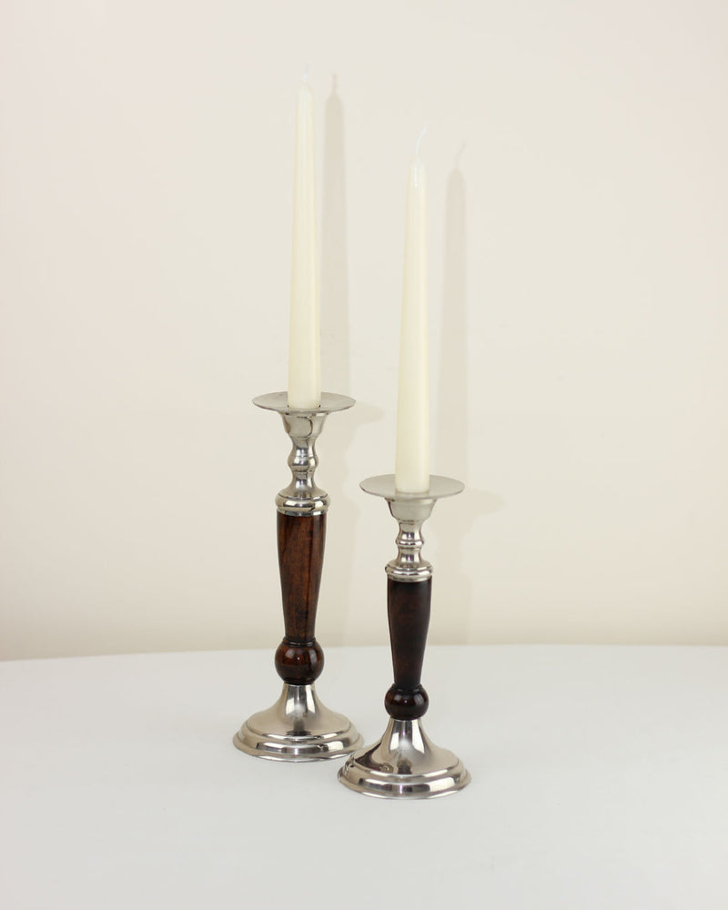 Pair of wooden and brass candlesticks with cream taper candles