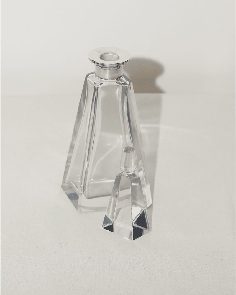 Art Deco crystal decanter with geometric angular design and silver cap
