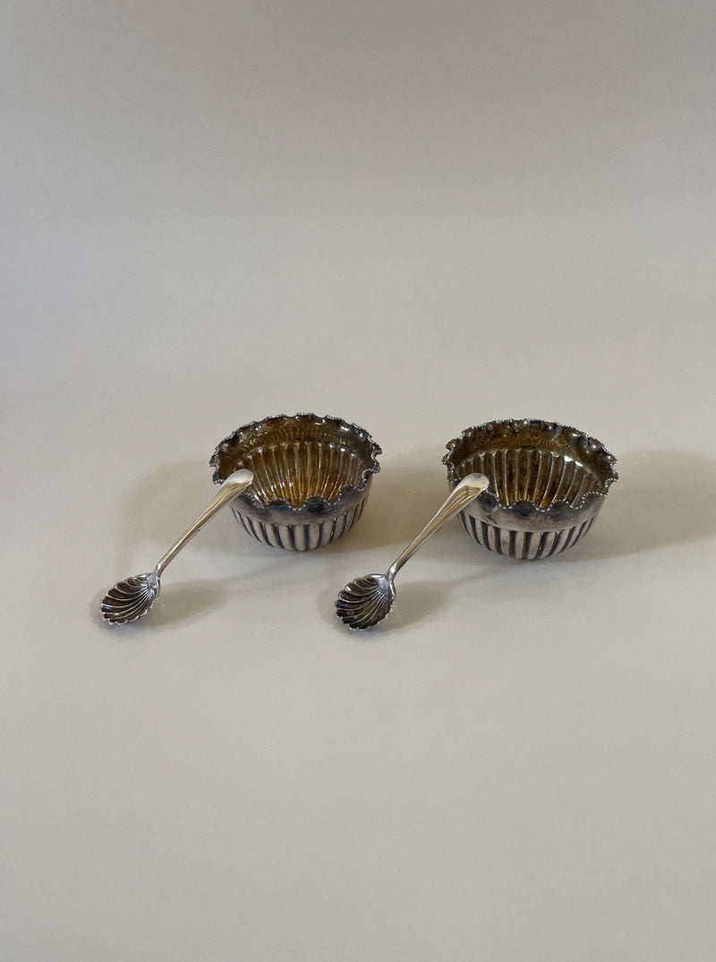 A pair of vintage Mappin and Webb silver salts with intricate detailing and elegant design