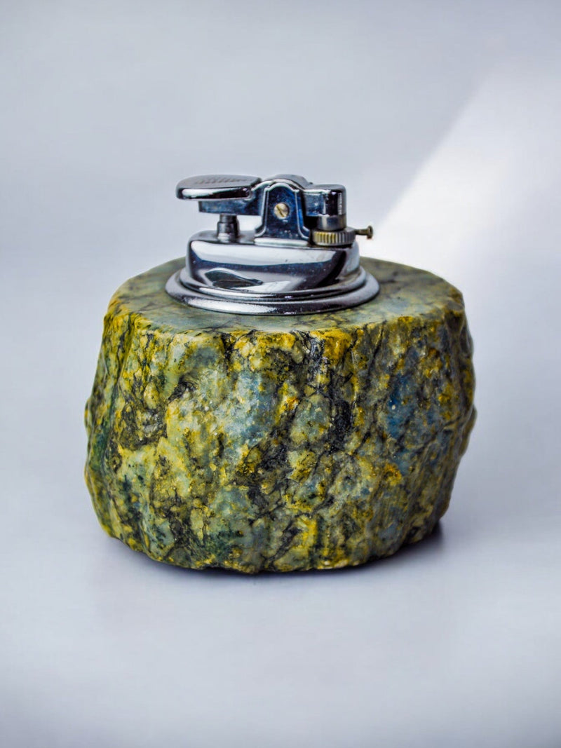 Green alabaster lighter detail showing marbled stone texture and chrome mechanism