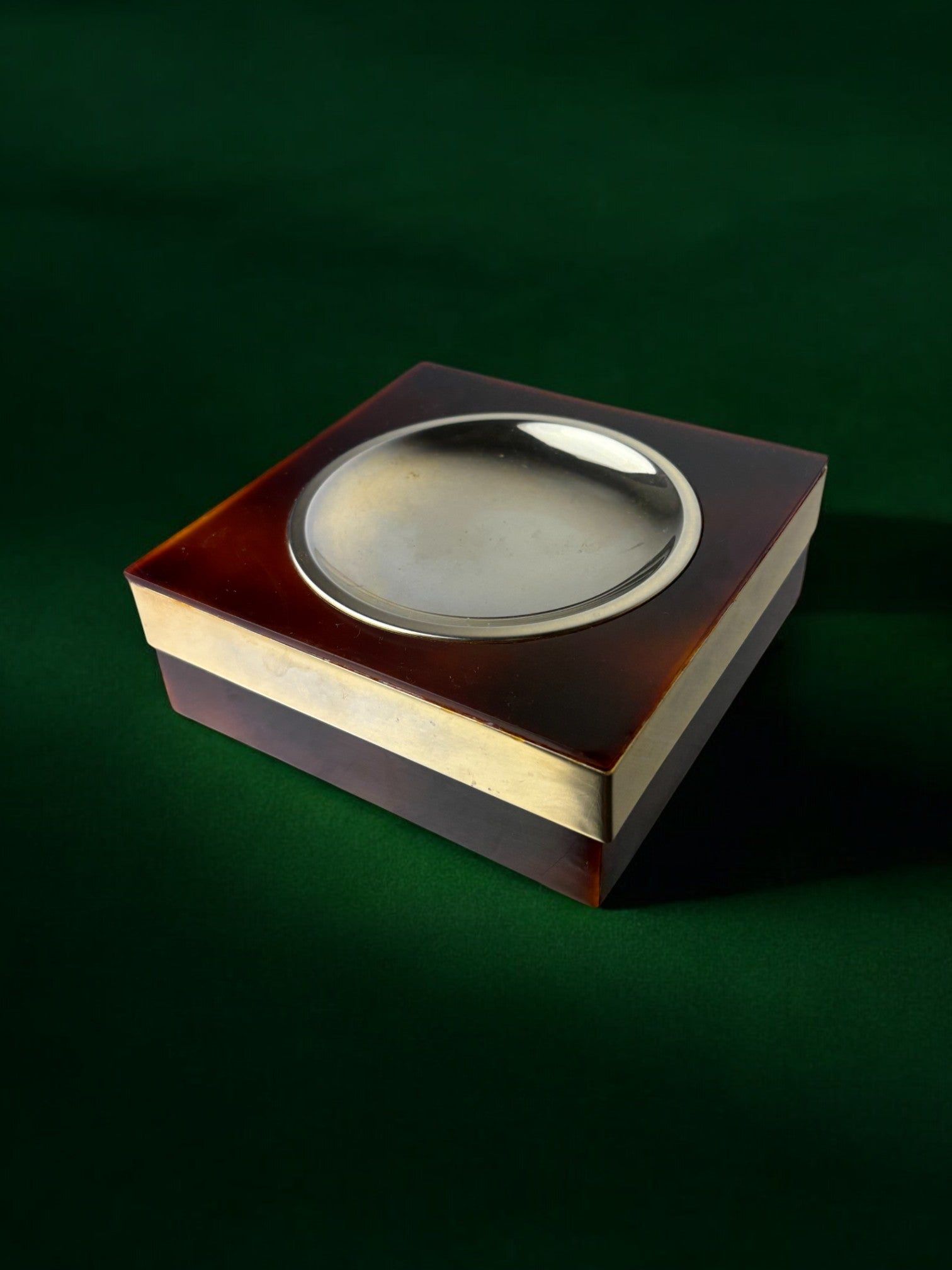 Faux tortoise shell ashtray on green surface, 1970s Italian design