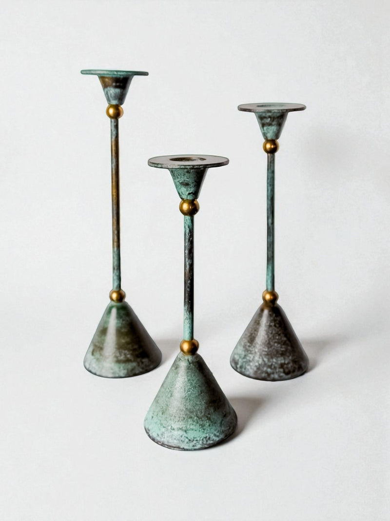 Set of three verdigris brass diabolo candleholders, France 1980s