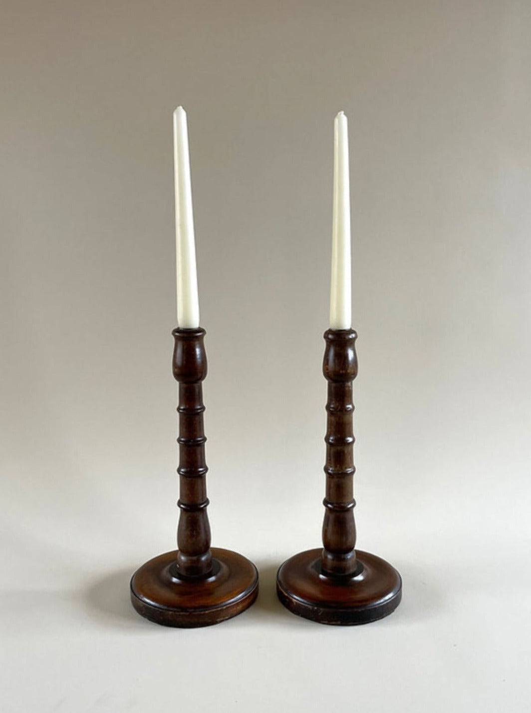 Pair of vintage turned wood candleholders with intricate carved details