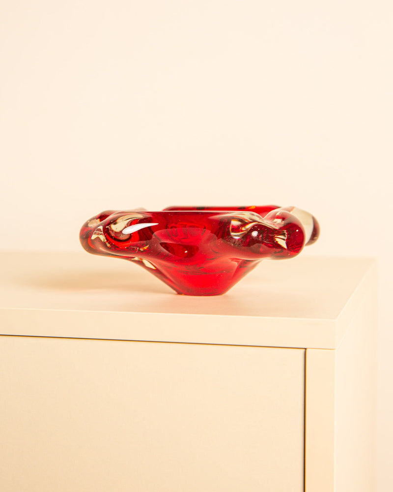 Red Murano glass flower vide-poche bowl on beige surface