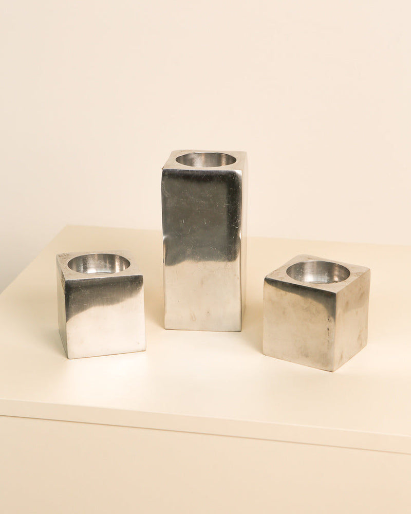 Three aluminum cube candleholders from the 1980s on neutral surface
