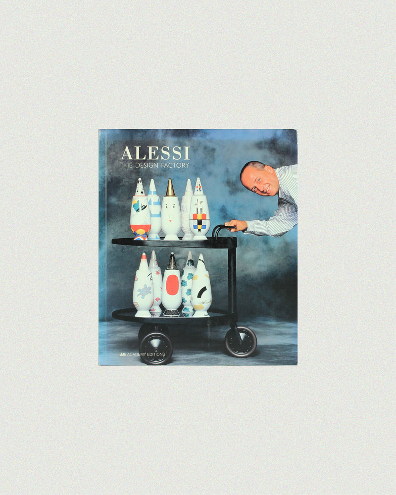 Alessi design book cover featuring designer with colorful vases on cart