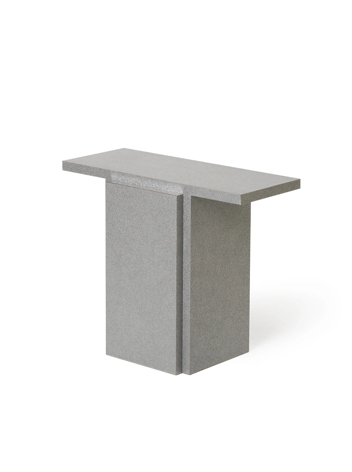 The "Mara T" Side Table – Silver Noise by TEGET is a modern and minimalist piece boasting a rectangular top and an inverted T-shaped base. With its textured gray finish and clean, geometric lines, it adds a contemporary touch. Set against a plain white background, it showcases stylish simplicity in laminated furniture design.