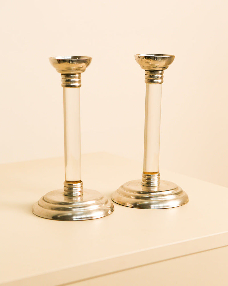 Pair of vintage silver and lucite candlesticks on neutral background