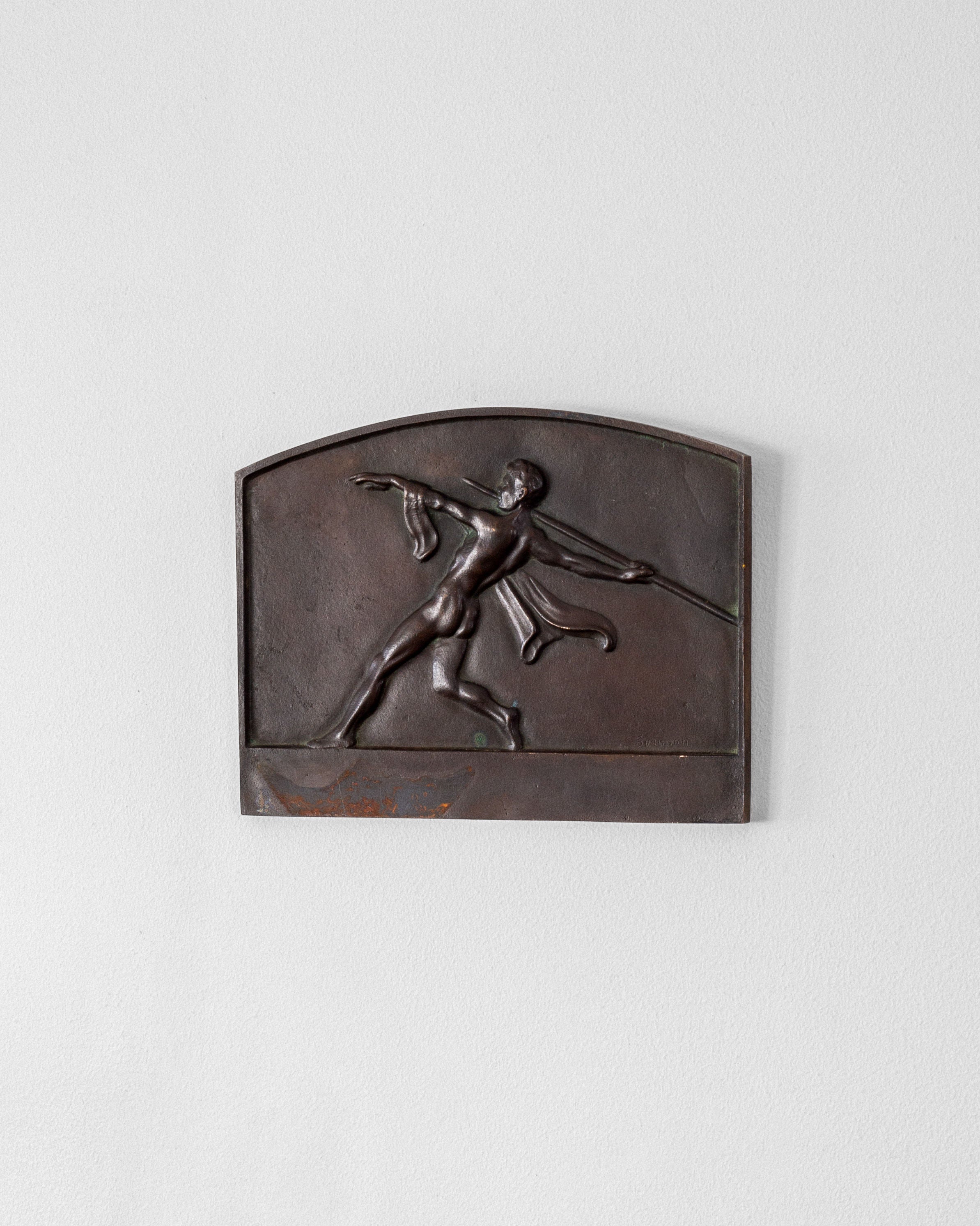 The Spigel Art Deco Bronze Wall Relief features a classic image of an athlete about to throw a javelin, highlighting the dynamic stance and flowing garment against a plain background, making it an elegant addition to any wall plaque collection.