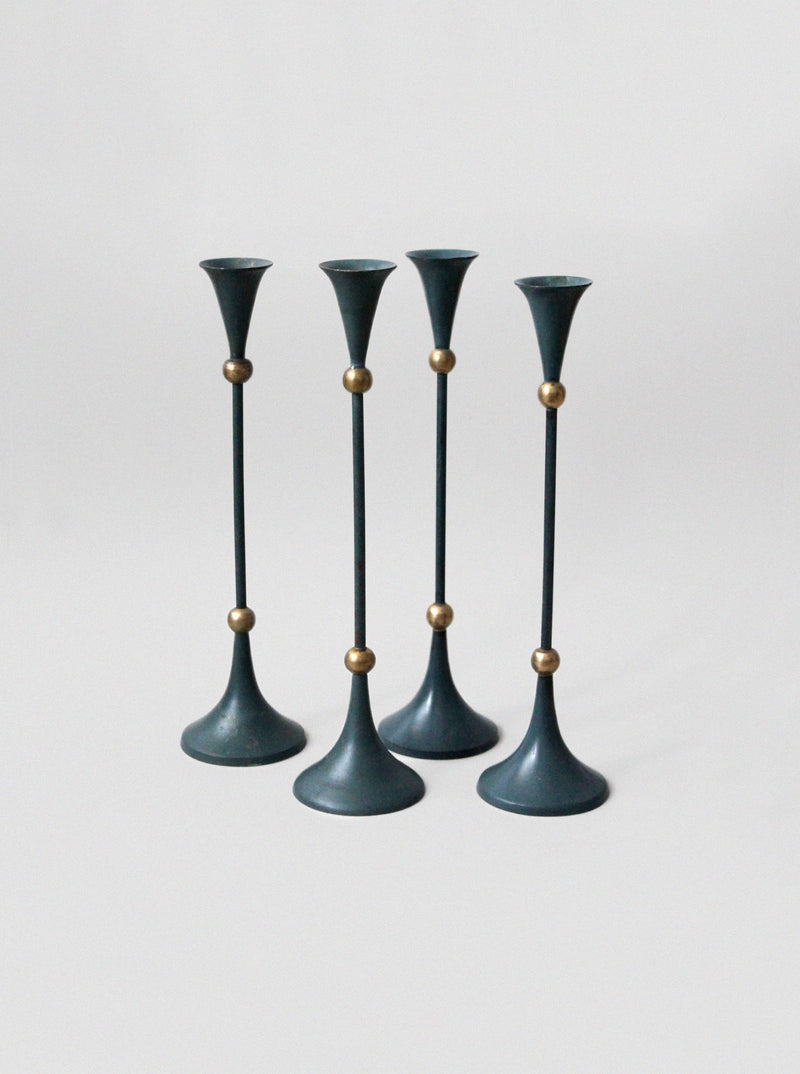 Set of four teal Memphis design candleholders with brass accents