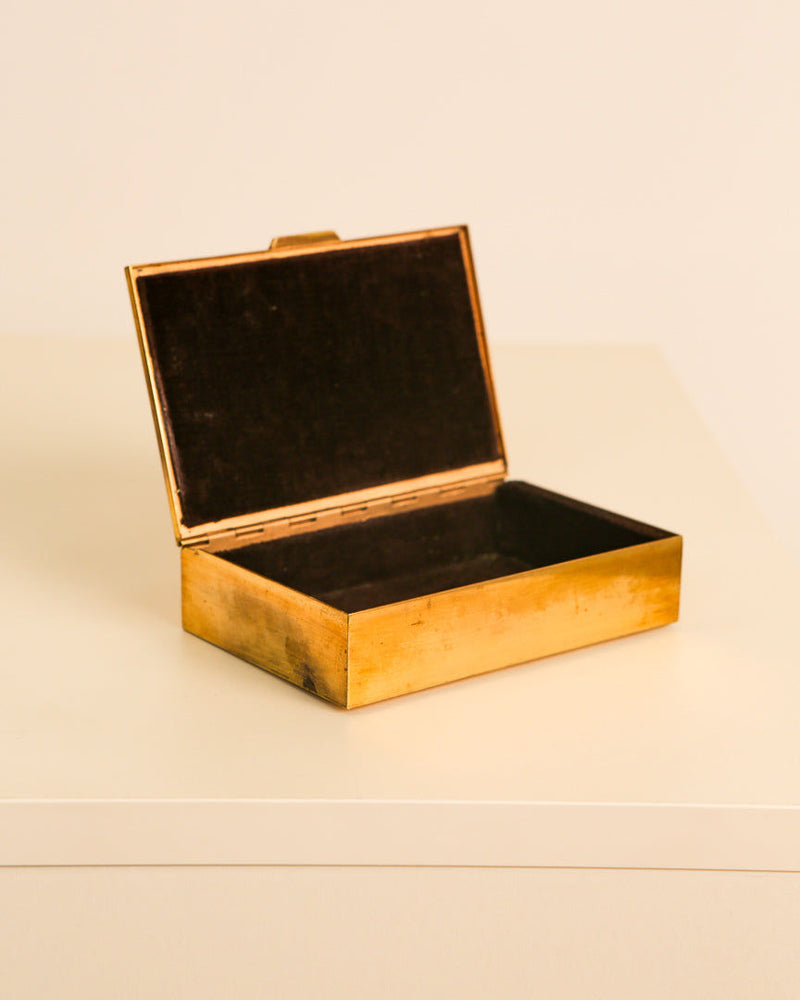 Open vintage Italian brass box with black velvet interior lining