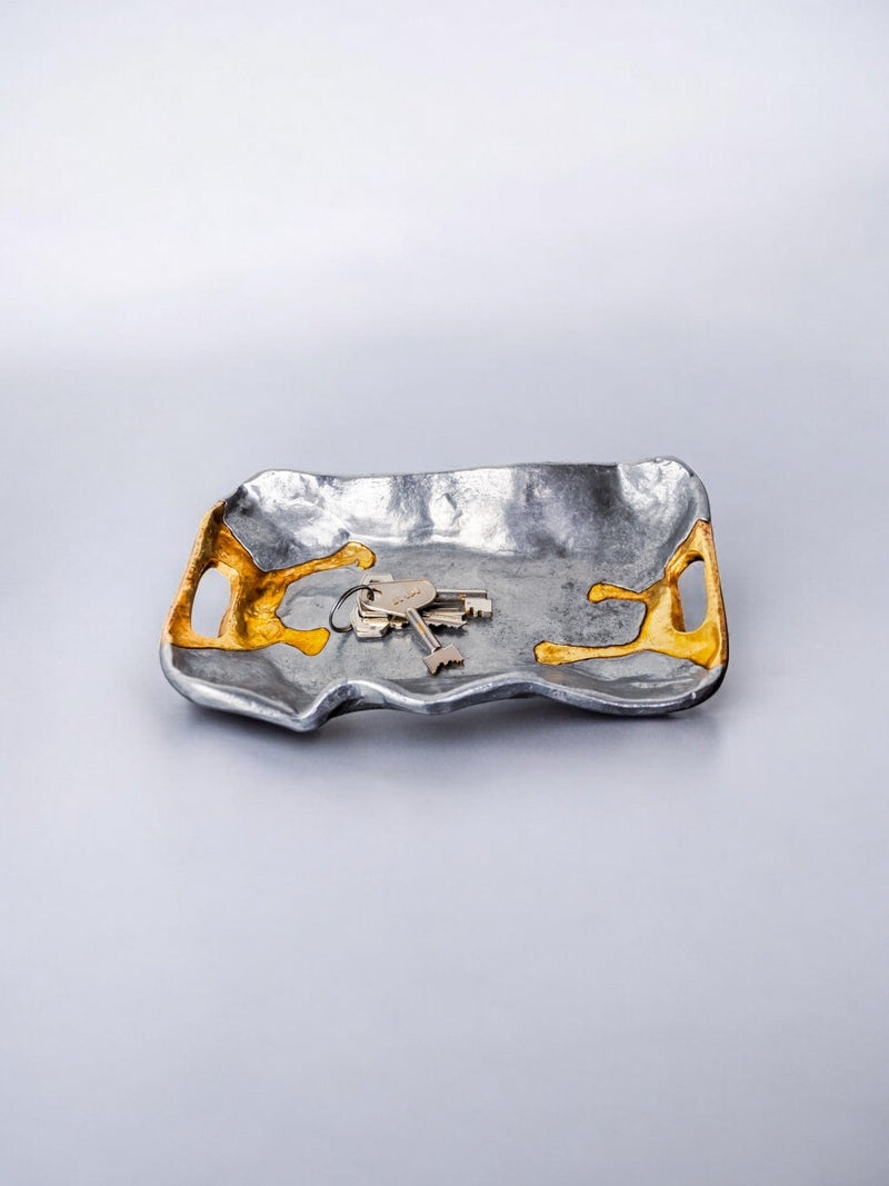 Brutalist aluminum vide-poche with gold accents holding keys