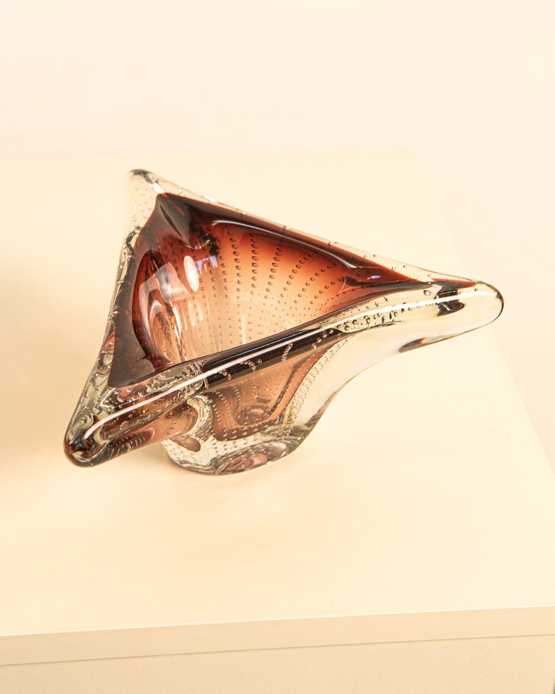 The Large Bubbled Murano Glass Tray 60s by Treaptyque is a triangular, clear tray with curved edges, dark brown to transparent gradient, and textured dotted details. Crafted by Italian artisans in the 1960s, it boasts a modern sculptural design.