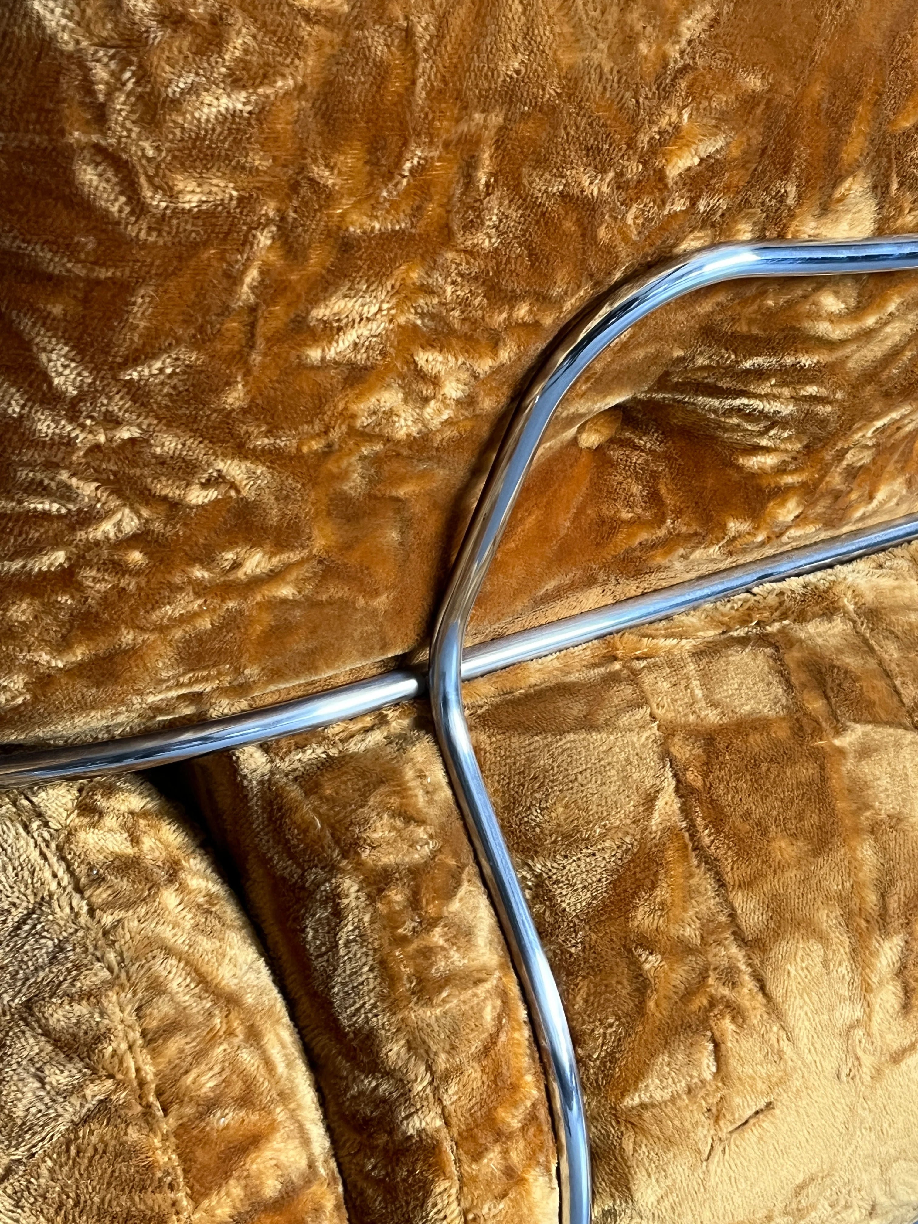 Close-up of the plush, brown textured fabric with a shiny metal bar diagonally crossing this ochre velvet material evokes a cozy Mid-Century charm, typical of the Adriano Piazzesi 'Okay' Sofa Seating Set from Cherry Cargo.