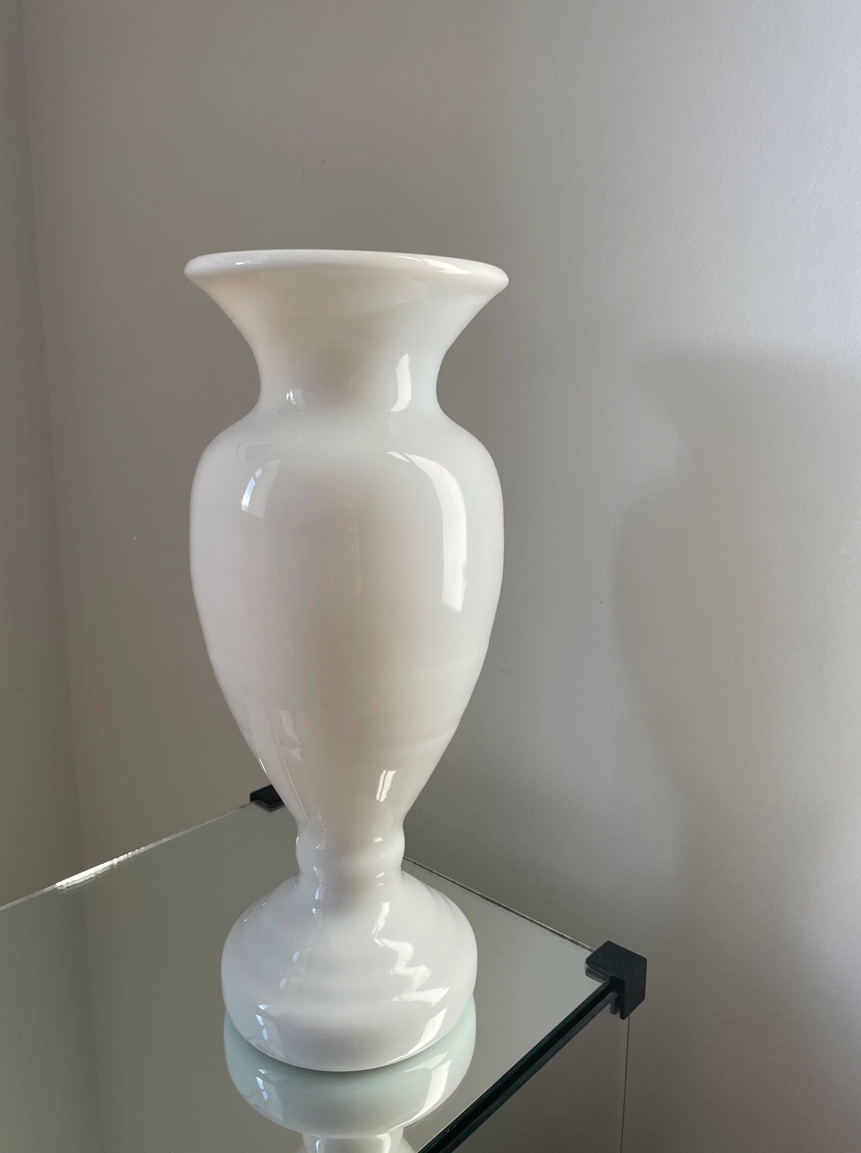 Beautiful white glass vase with elegant curved shape and smooth finish