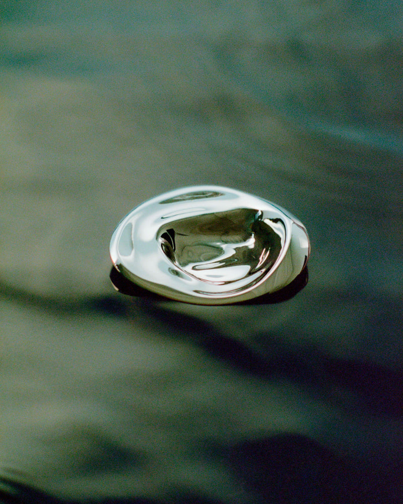 Large titanium ripple hook showing curved reflective surface detail