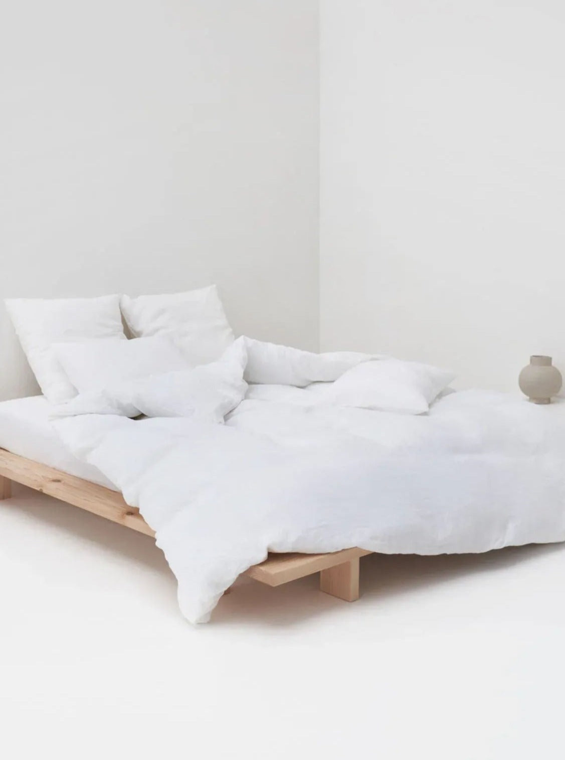 White Washed Linen Bed Set — side angle on minimalist wooden bed