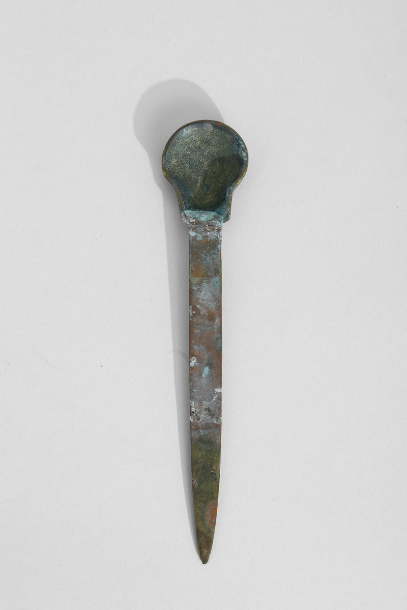 Vintage brass shell letter opener with patinated finish and pointed blade